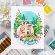 Colorful illustration of a camper with trees and text on a white background, surrounded by craft supplies.