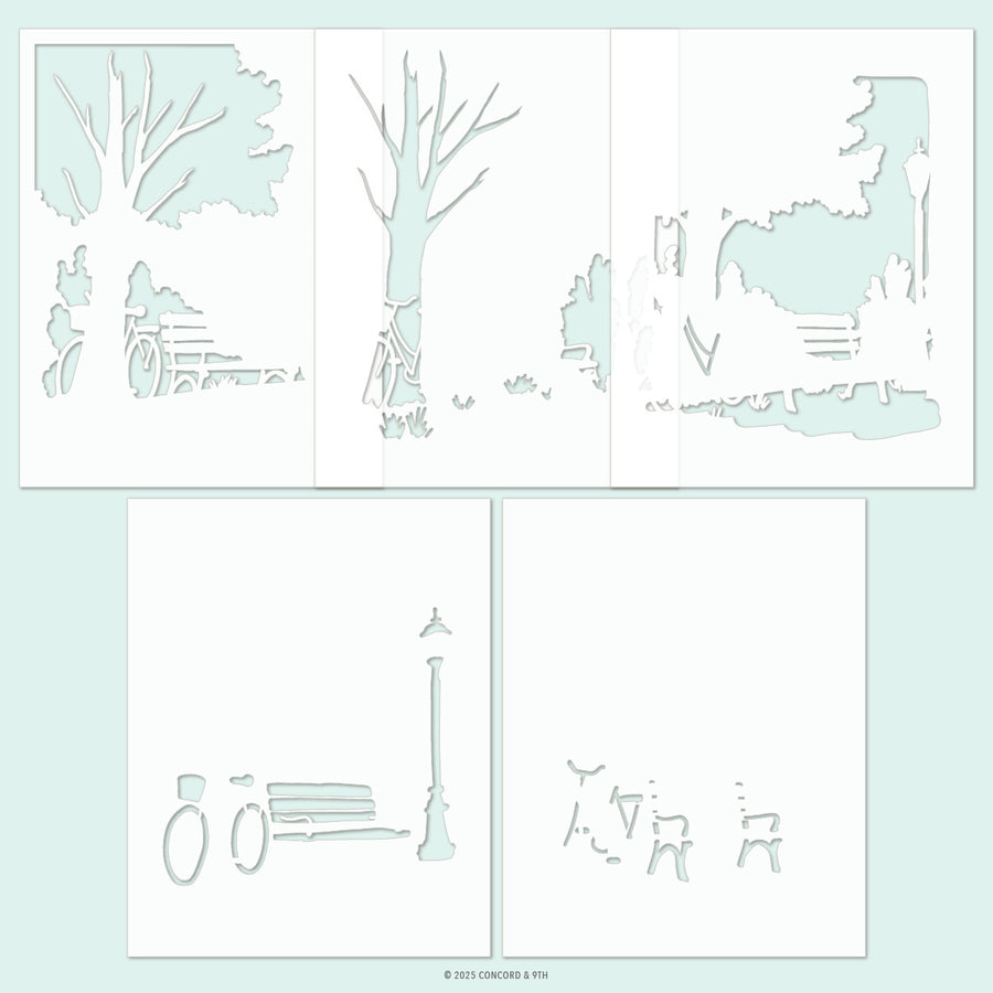 A set of six white die-cut paper stencils featuring minimalist park and street scene illustrations, including trees, benches, lampposts, and figures, arranged on a pale mint green background. Concord & 9th Park Bench Stencil Pack