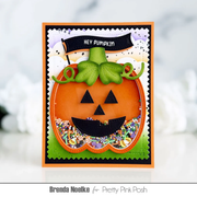 A handmade Halloween greeting card featuring a 3D layered jack-o'-lantern with a green stem, black facial features, and a colorful floral shaker underneath. The card has a black banner that reads 'HEY PUMPKIN' and is displayed on a light, blurred background.