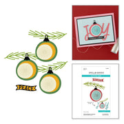 Three decorative ornament graphics with sliced lemon centers, green pine branches, and a small 'HAPPY' banner on a white background, alongside a red card sample reading 'Sending Cheers' and a Spellbinders card design sheet. Spellbinders Stitched Baubles & Boughs Etched Dies