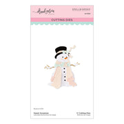 A package of Spellbinders Paper Arts cutting dies called Sweet Snowman designed by Franl Garcia and features a cute snowman design. The packaging is white with a pink header and a light blue scalloped stripe, displaying a die-cut illustration of a snowman wearing a black top hat, peach scarf, and mint green scarf.