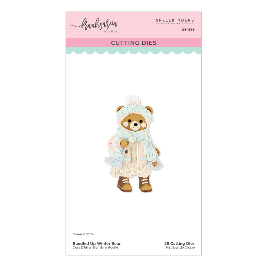 Spellbinders Paper Arts 'Bundle Up Winter Bear' by Frank Garcia cutting dies package, showing a crafted bear in a light blue winter coat, hat, and scarf with brown boots, on a white card with pink and mint blue header details.