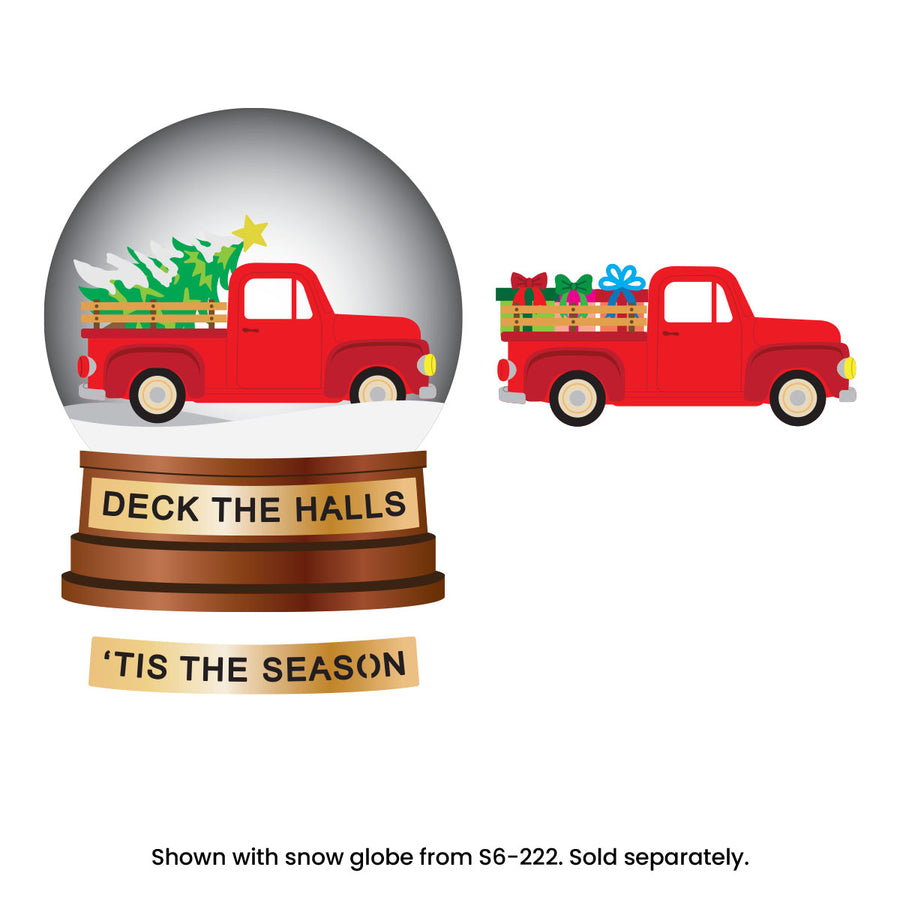 A holiday snow globe product shown on a white background, with a large front view of the snow globe and a smaller side view of the red pickup truck inside. The base reads 'DECK THE HALLS' and 'TIS THE SEASON. Spellbinders Holiday Truck Scene Etched Dies by Simon Hurley