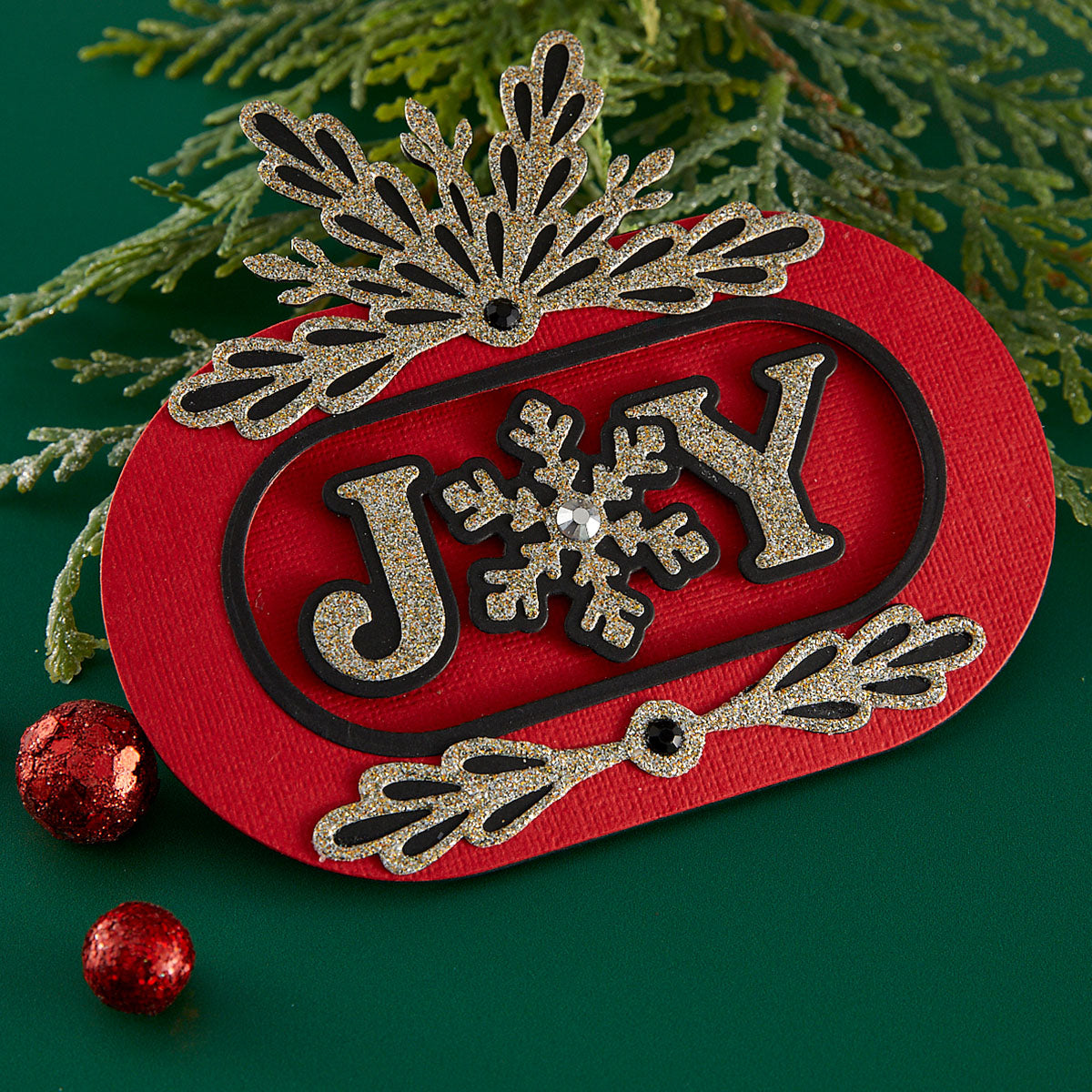 Decorative Christmas card with 'JOY' and snowflake design on a red background using Spellbinders Layered Snowflakes Etched Dies by Lisa Horton