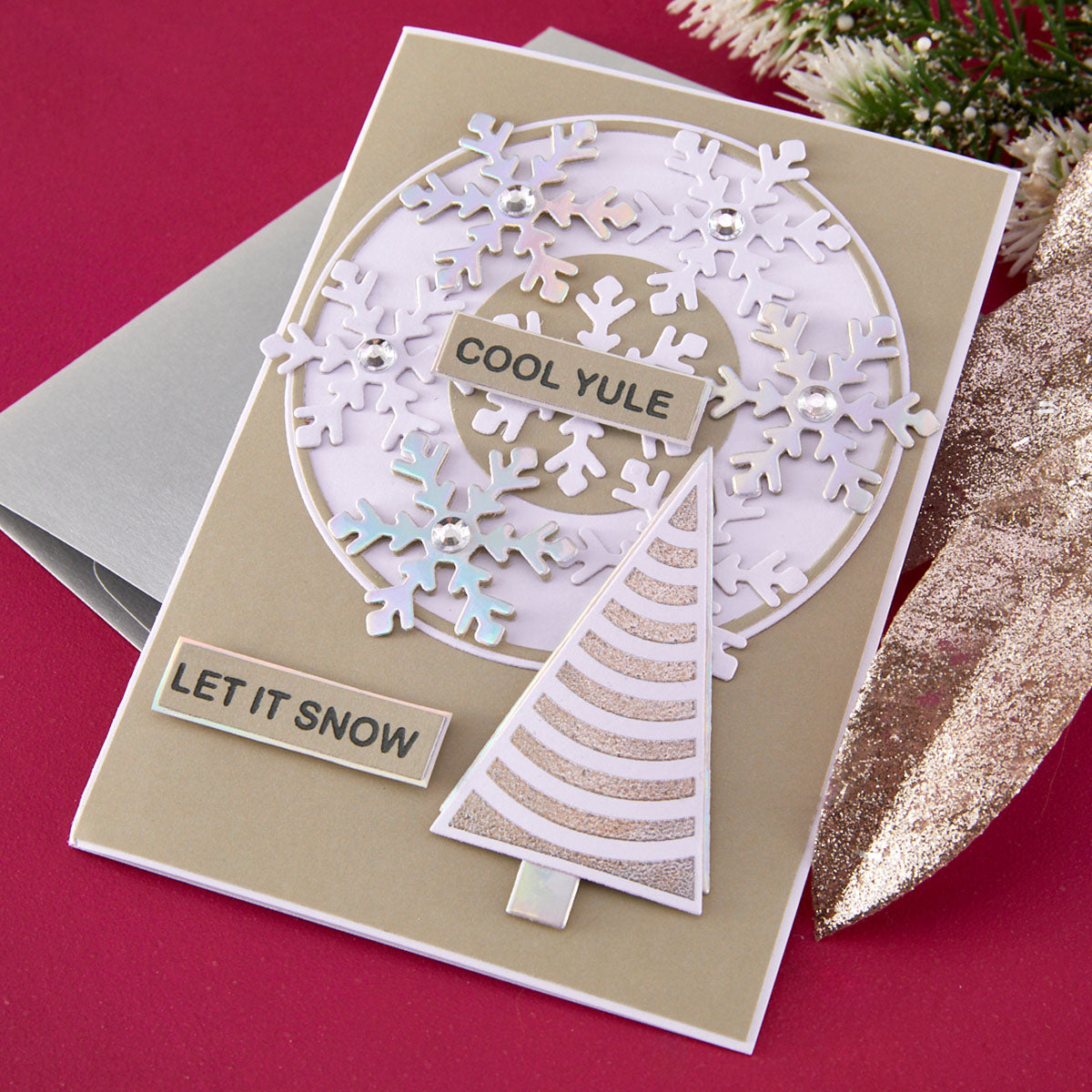 Christmas card with snowflake design and text on a red background