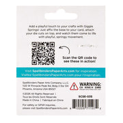 Back of a retail card for Spellbinders PaperArts Giggie Springs, showing product description, QR code, website, warning label, and barcode on a white card.