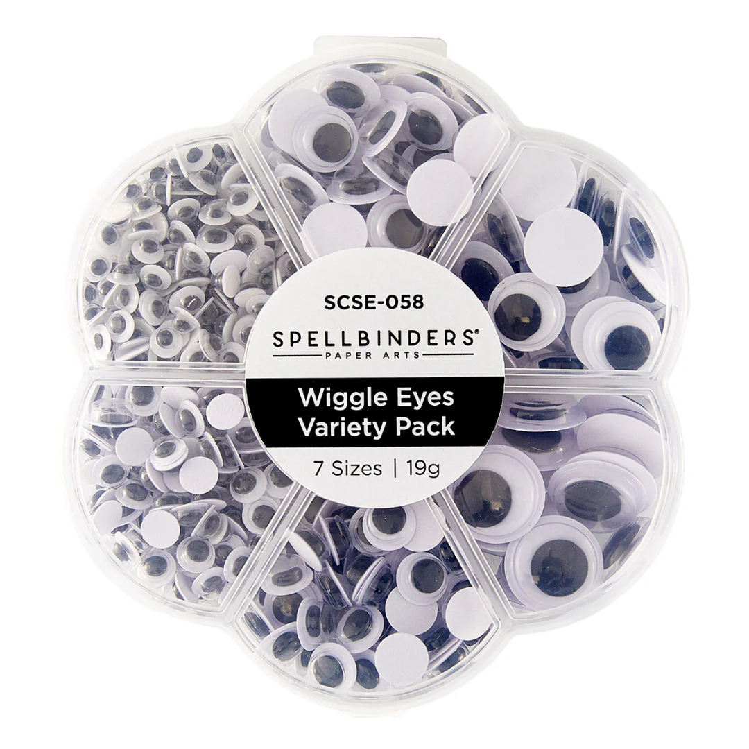 Spellbinders Paper Arts Wiggle Eyes Variety Pack in a clear plastic clamshell container with seven compartments, showing a mix of white, black, and gray googly eyes in different sizes.