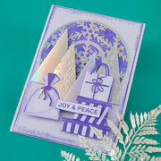 Decorative card with cut-out shapes and 'Joy & Peace' text on a teal background