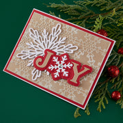 Christmas card with 'JOY' text and snowflake design on a green background