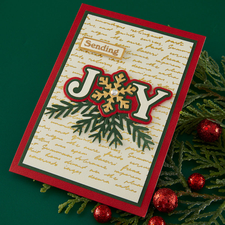 Christmas card with 'Joy' design on a green background with red berries