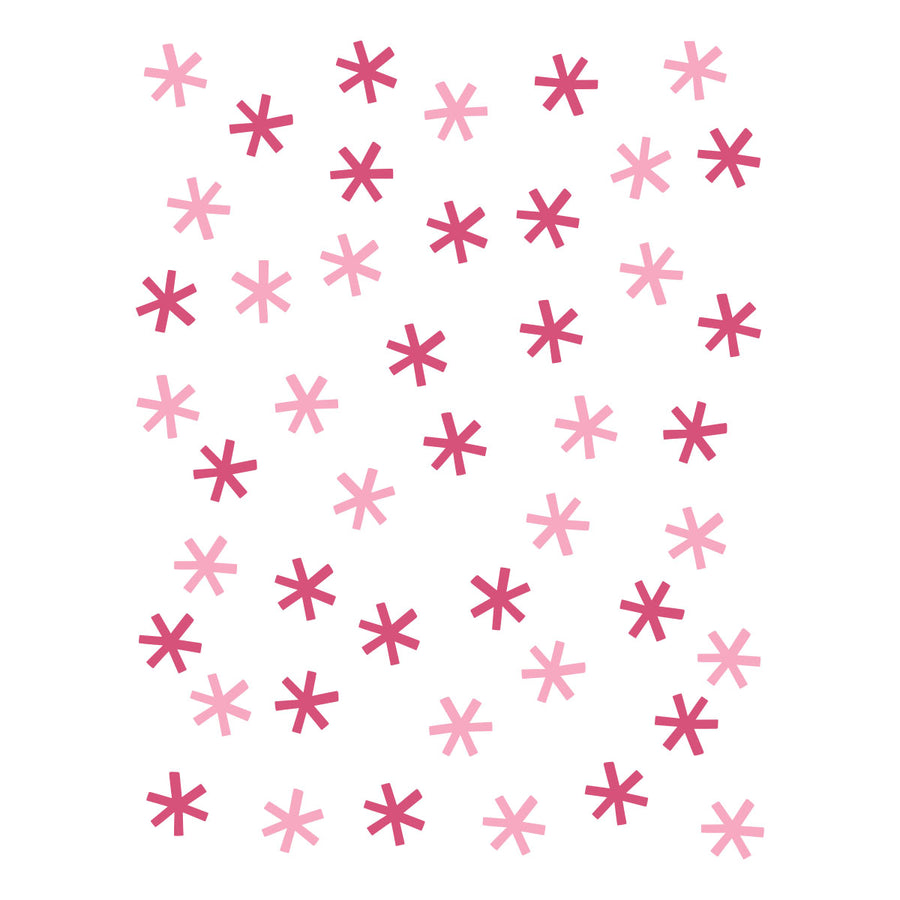A repeating pattern of small six-pointed stars in light pink, medium pink, and dark magenta on a plain white background. Spellbinders Snow Joy Stencil