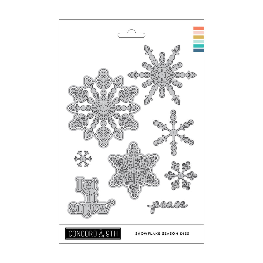 Concord & 9th Snowflake Season Dies set on a white backing card, featuring multiple silver metal snowflake and text dies including 'Let it snow' and 'peace'.