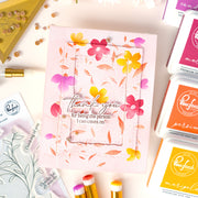 A handmade thank you card with layered pink floral frames and the text 'thank you for being the person I can count on!' surrounded by craft supplies, including Pond's ink pads and stamping tools on a light pink background.