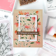 Floral card with 'Thanks for being part of my journey' text on a crafting surface with stamps and tools.