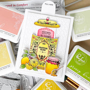 A handmade greeting card featuring a layered autumn-themed 'Gratitude Blend' design with lemon slices, a honey pot, and a yellow hat, surrounded by various Ranger Fresh premium dye ink pads.