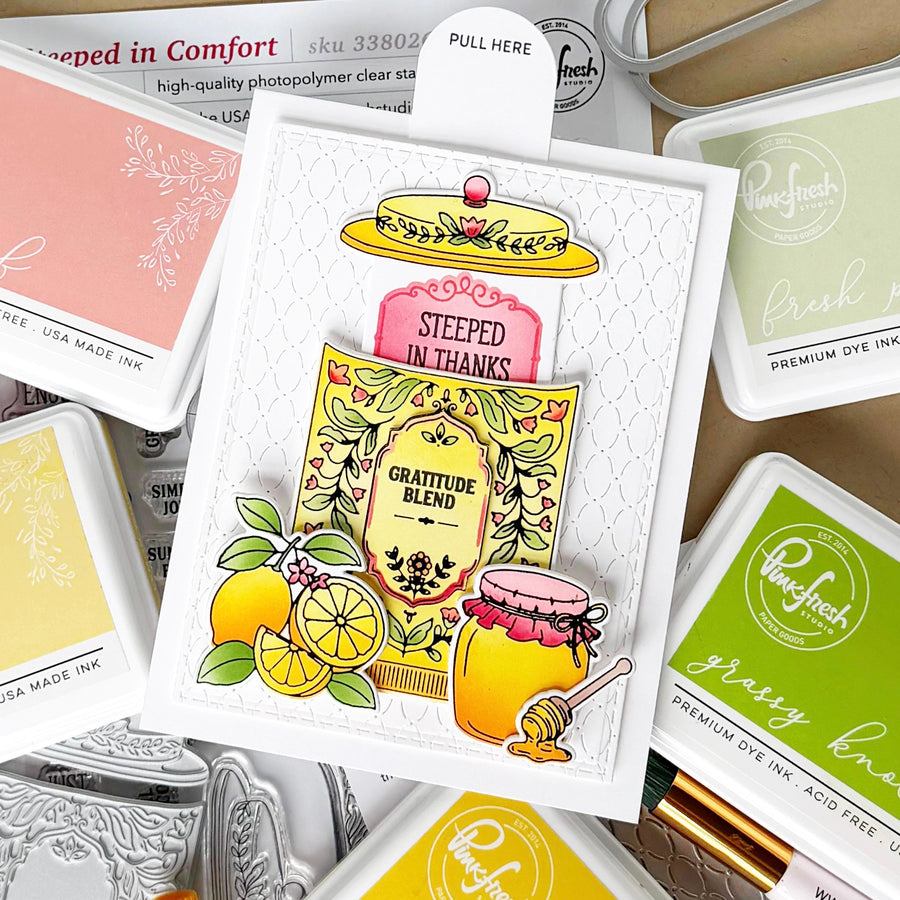 A handmade greeting card featuring a layered autumn-themed 'Gratitude Blend' design with lemon slices, a honey pot, and a yellow hat, surrounded by various Ranger Fresh premium dye ink pads.