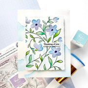Floral card with 'Thinking of you' text on a light blue background