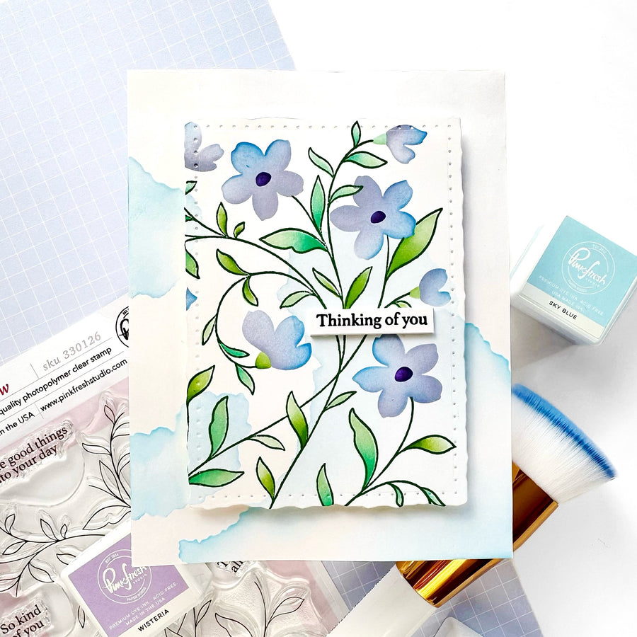 Floral card with 'Thinking of you' text on a light blue background