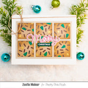 A handmade Christmas greeting card featuring a 3x2 grid of gingerbread cookie designs with green Christmas trees, brown sprinkles, and gold stars, with 'Merry Christmas' written across the center. The card is styled with pine branches and Christmas ornaments on a light background.