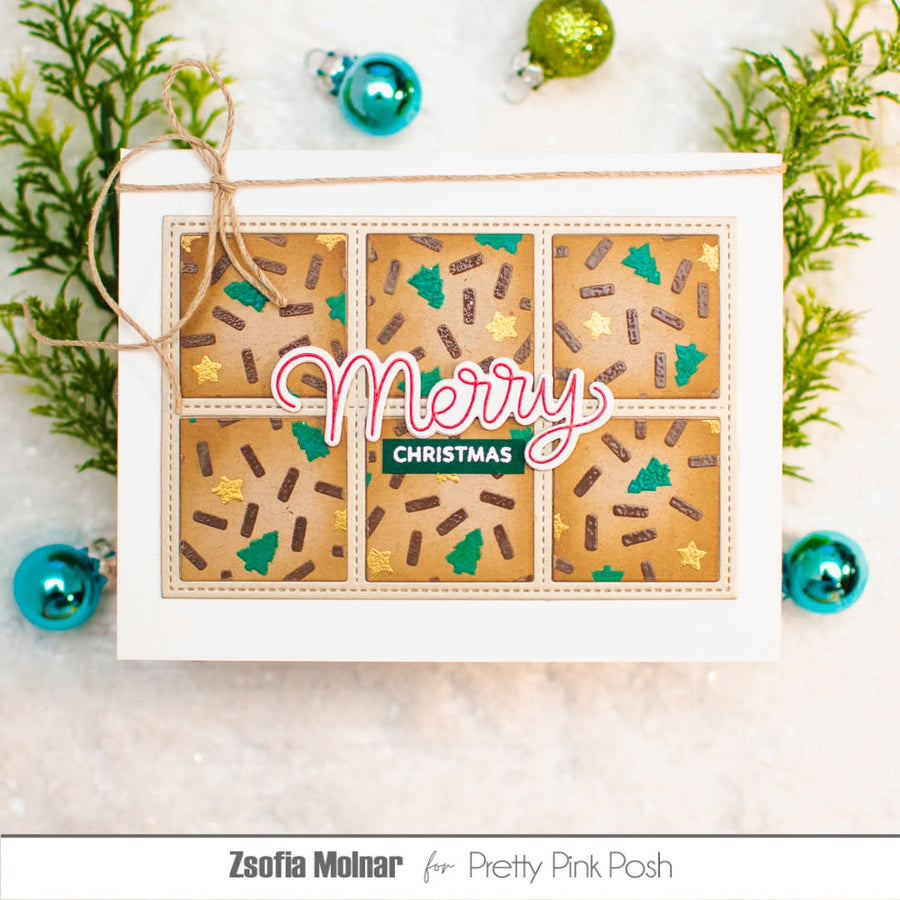A handmade Christmas greeting card featuring a 3x2 grid of gingerbread cookie designs with green Christmas trees, brown sprinkles, and gold stars, with 'Merry Christmas' written across the center. The card is styled with pine branches and Christmas ornaments on a light background.