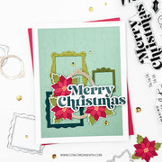 A handmade Christmas greeting card with layered green frames, red poinsettias, and the text 'Merry Christmas' in white with dark blue outlines, styled on a white background with crafting tools and gold confetti.