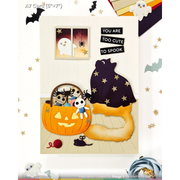 A Halloween-themed A6/A7 card design featuring a cream background with layered craft elements: a jack-o'-lantern basket holding two cute ghost characters, a large fluffy orange tail, a black cat wearing a starry purple cape, a small black mouse, red yarn, bats, and the text 'YOU ARE TOO CUTE TO SPOOK'.