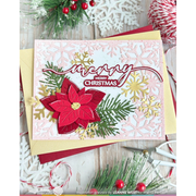 A handmade Christmas greeting card with a red poinsettia, green pine branches, gold snowflakes, and a 'Merry Christmas' stamp, styled on a wooden surface with holiday props.