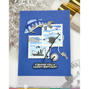 A handmade birthday card featuring a blue embossed background with layered fishing-themed postage stamp designs, fish cutouts, a fishing rod, and the text 'FISHING YOU A HAPPY BIRTHDAY'.