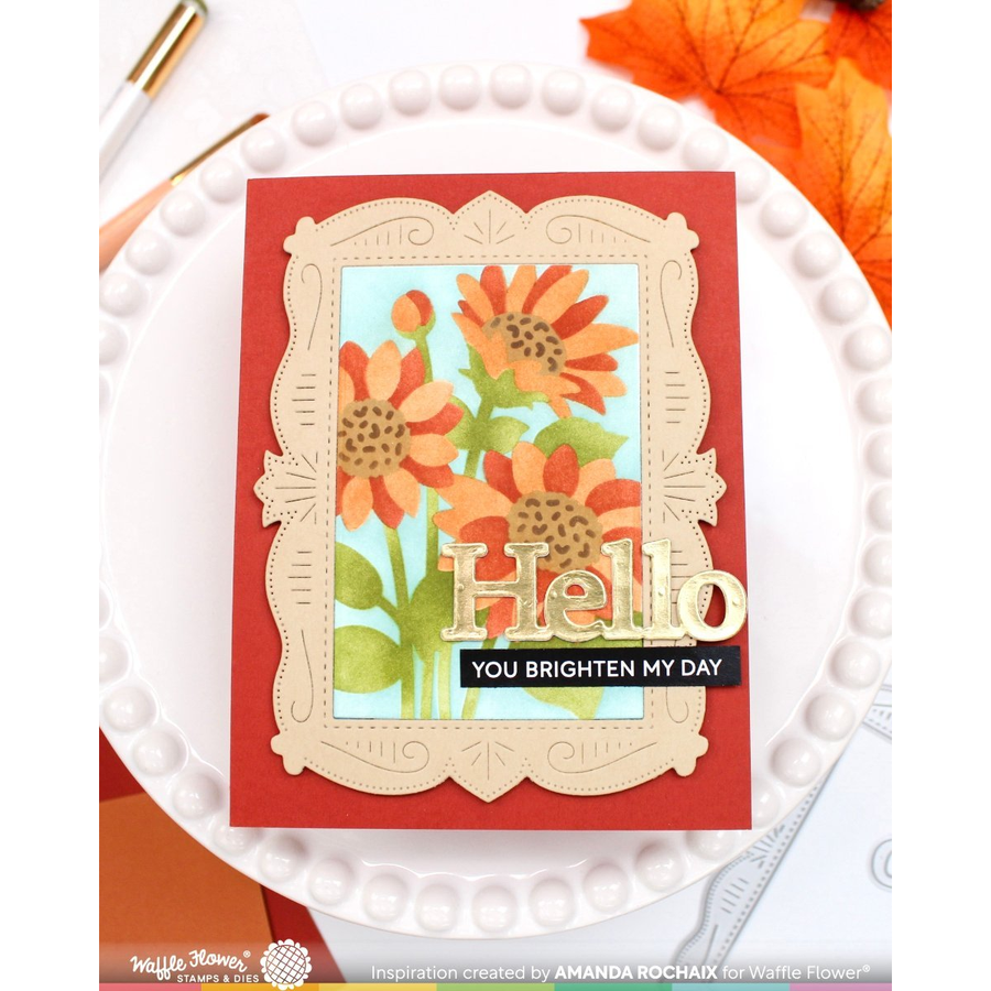 A handmade greeting card featuring layered floral sunflower artwork, a red border, and the words 'Hello YOU BRIGHTEN MY DAY' in gold and black, displayed on a white scalloped plate.