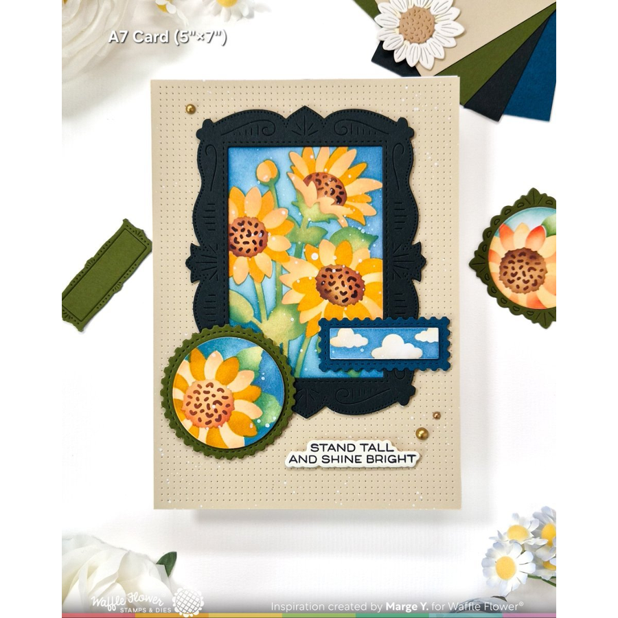 A handmade A7 card featuring a sunflower illustration with a black ornate frame, a blue sky window, and a cloud banner, with the text 'STAND TALL AND SHINE BRIGHT'.