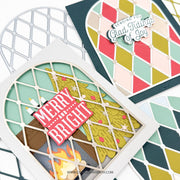 A close-up of layered handmade holiday cards featuring a Christmas tree, a red 'Merry and Bright' sign, and geometric diamond patterns in mint, pink, yellow, and navy. One card includes a die-cut phrase 'Sending You Glad Things of Joy.