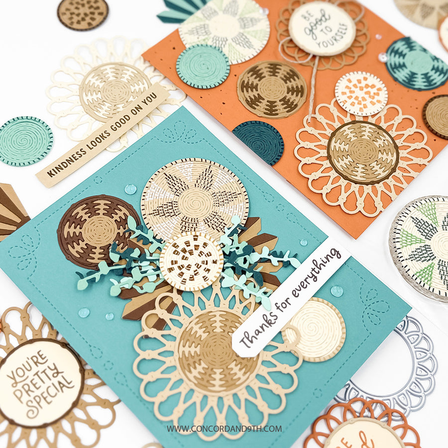 Two handmade layered greeting cards displayed on a white background, one in teal and one in orange, decorated with laser-cut circular patterns in beige, gold, brown, and teal. Small decorative tags and circular embellishments are arranged around them.