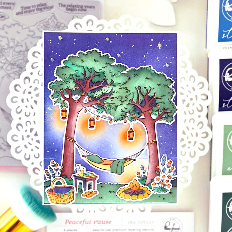 Illustration of a peaceful outdoor scene with trees, hammock, and picnic setup on a decorative card.