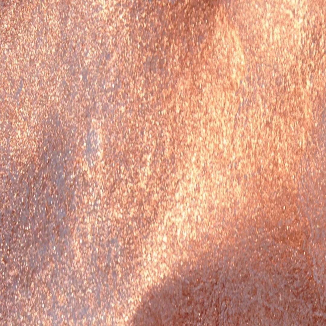 A close-up texture swatch of shimmering rose gold glitter with warm coppery metallic tones and fine sparkling particles. Lindy's Gang Cowabunga Copper Starburst Spray