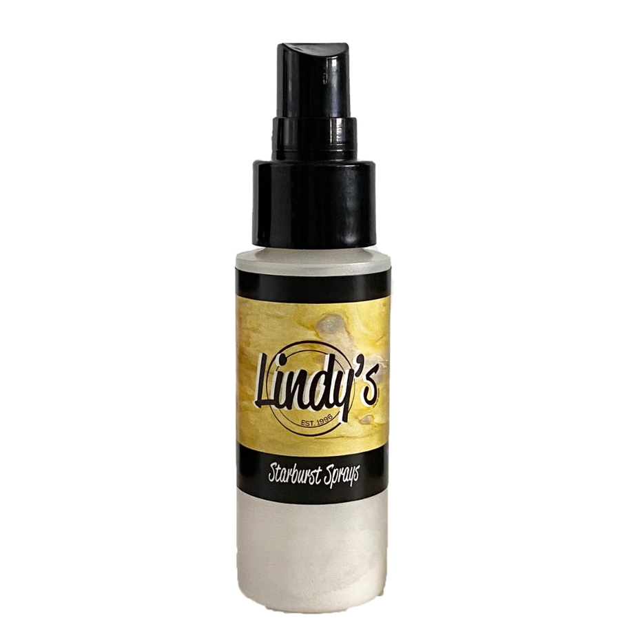 A bottle of Lindy's Starburst Sprays with a black spray nozzle and a gold and black label, shown against a plain white background. Lindy's Gang Glory of the Seas Gold Starburst Spray