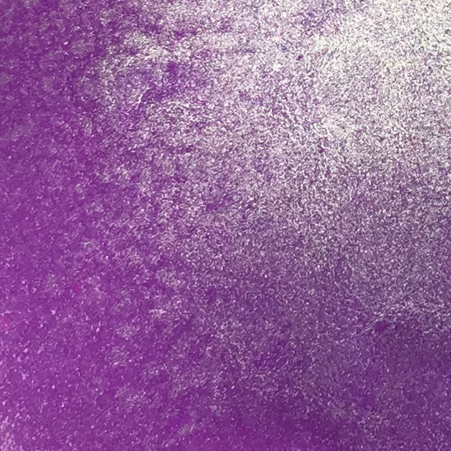 A close-up of a textured purple surface with a metallic silver sheen, showing a gradient from deep purple on the left to lighter silvery purple on the right. Lindy's Gang Prima Donna Purple Starburst Spray