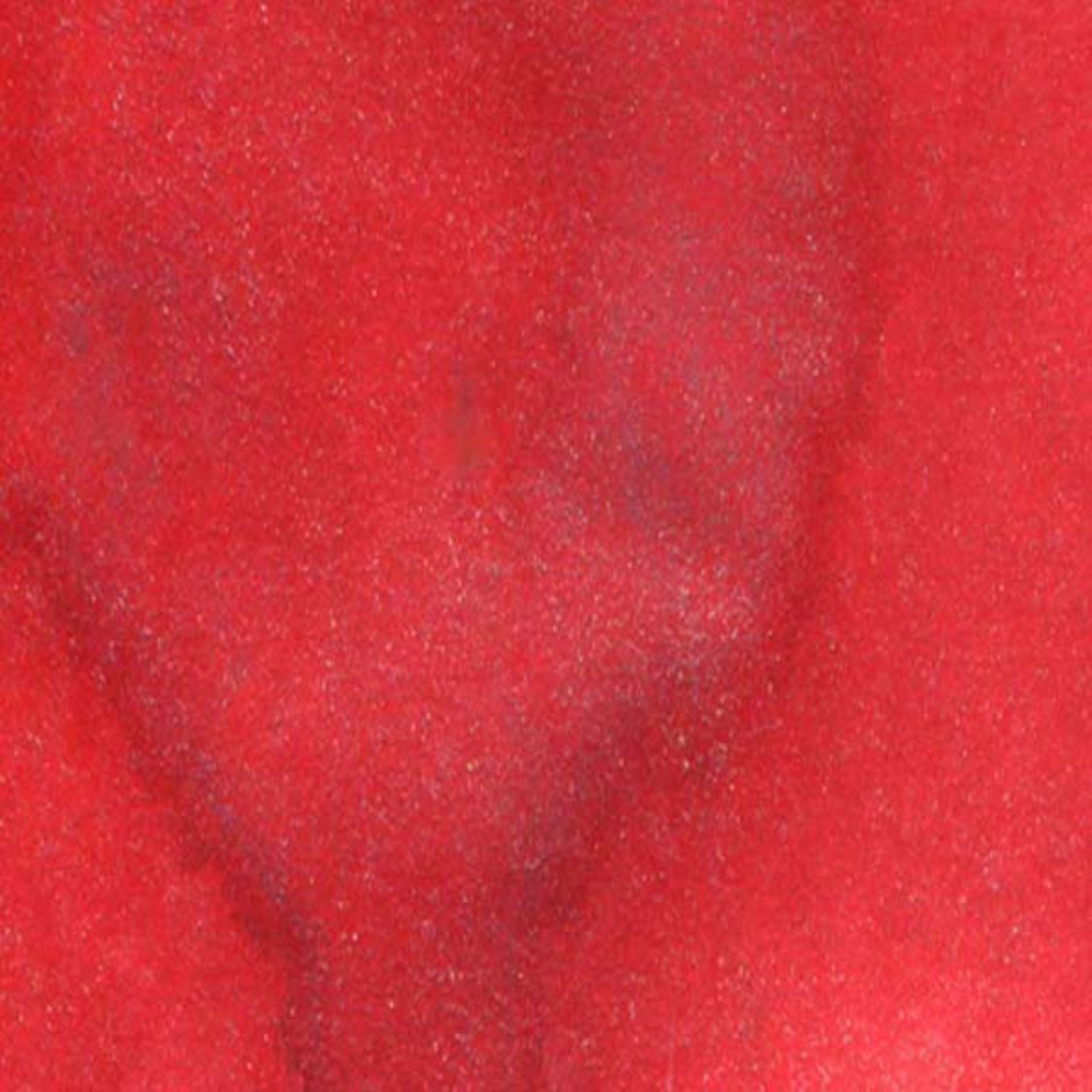 A close-up texture shot of a vibrant red swatch. Lindy's Gang Rudolph's Nose Red Starburst Spray