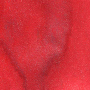 A close-up texture shot of a vibrant red swatch. Lindy's Gang Rudolph's Nose Red Starburst Spray